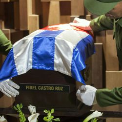 The small coffin containing the ashes of the late Cuban leader Fidel Castro is placed by honor guards at the Ernesto "Che" Guevara mausoleum in Santa Clara, Cuba, early Thursday, Dec. 1, 2016. Castro's ashes completed the first leg of a four-day journey across Cuba from Havana to their final resting place in the eastern city of Santiago. 