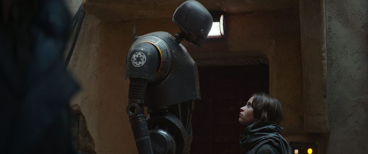 The droid K-2SO (Alan Tudyk) towers over Jyn Erso (Felicity Jones) in Rogue One