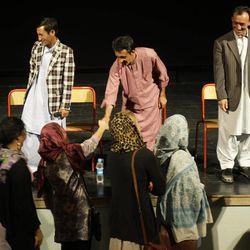 In this Sept. 22, 2011 photo, Afghan Noshaq mountain climbers Gurg Ali, Amruddin Sanjar and Malang Daria, from left, present on the stage after the "24,000 Feet Above The War" screening at the French Institute of  Afghanistan in Kabul, Afghanistan. 