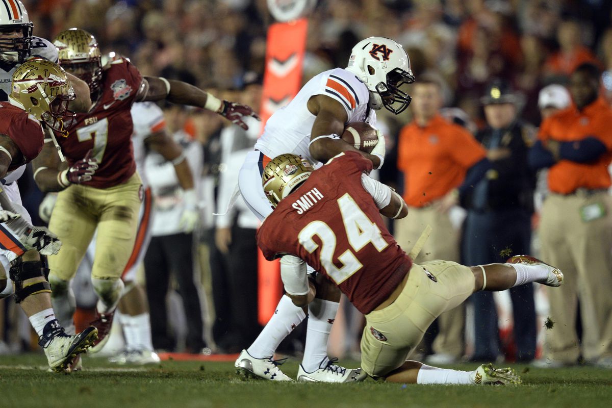 Terrance Smith tackles an Auburn player in the 2014 BCS National Championship game.