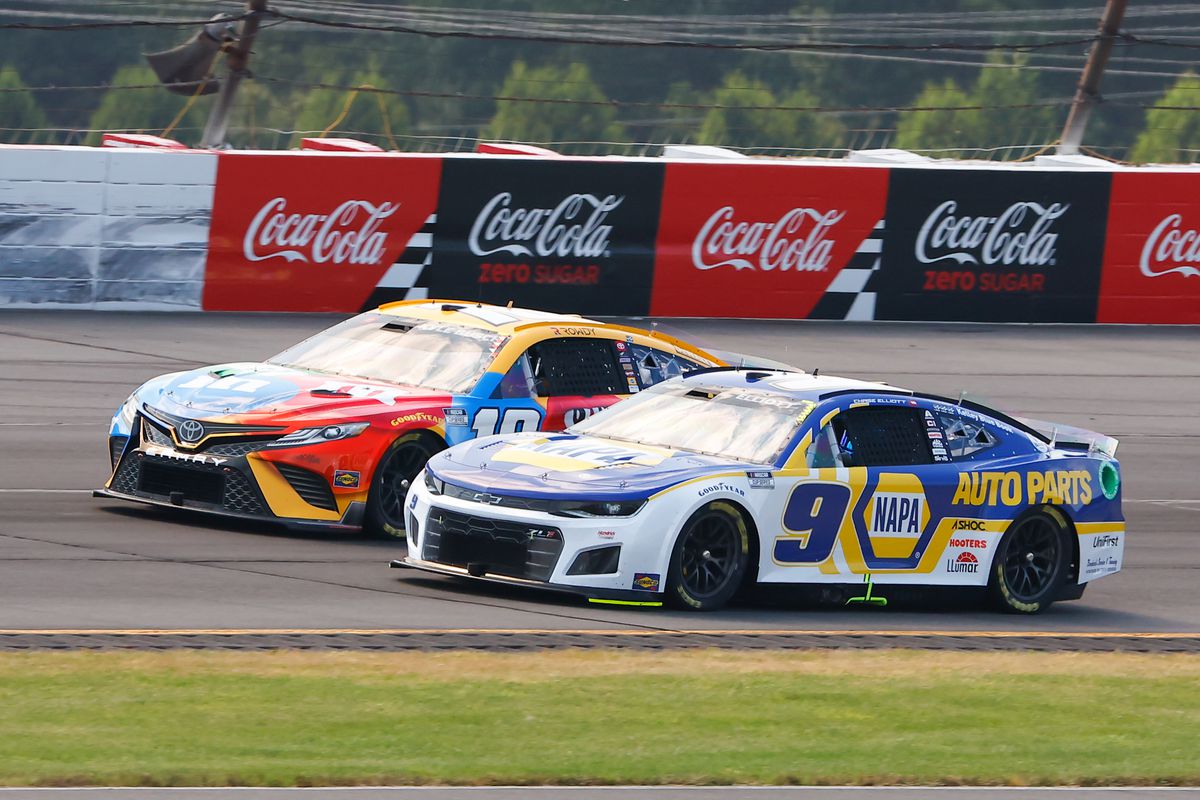 Chase Elliott (#9 Hendrick Motorsports NAPA Auto Parts Chevrolet) and Kyle Busch (#18 Joe Gibbs Racing M&amp;M’s Toyota) drive during the NASCAR Cup Series M&amp;MS Fan Appreciation 400 on July 24, 2022 at Pocono Raceway in Long Pond, Pennsylvania.