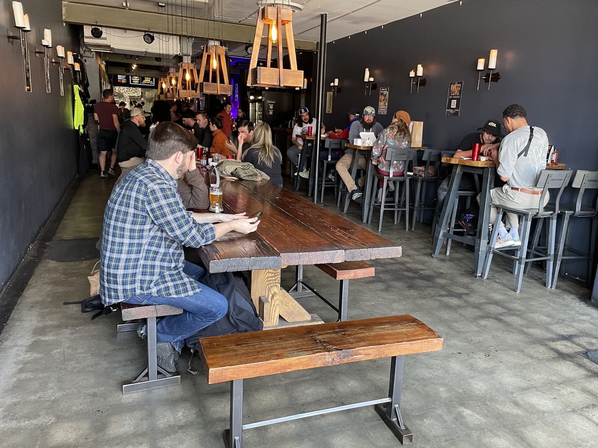 Patrons sit at tables inside TRVE Brewing Company