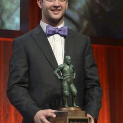 Alabama quarterback AJ McCarron poses with the Maxwell Award after winning the honor during the College Football Awards show in Lake Buena Vista, Fla., Thursday, Dec. 12, 2013. 