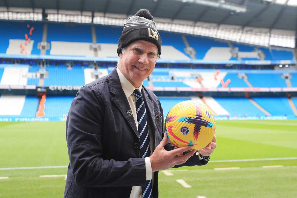 Will Ferrell poses for a photo with the match ball prior to the Premier League match between Manchester City and Aston Villa at Etihad Stadium on February 12, 2023 in Manchester, England.