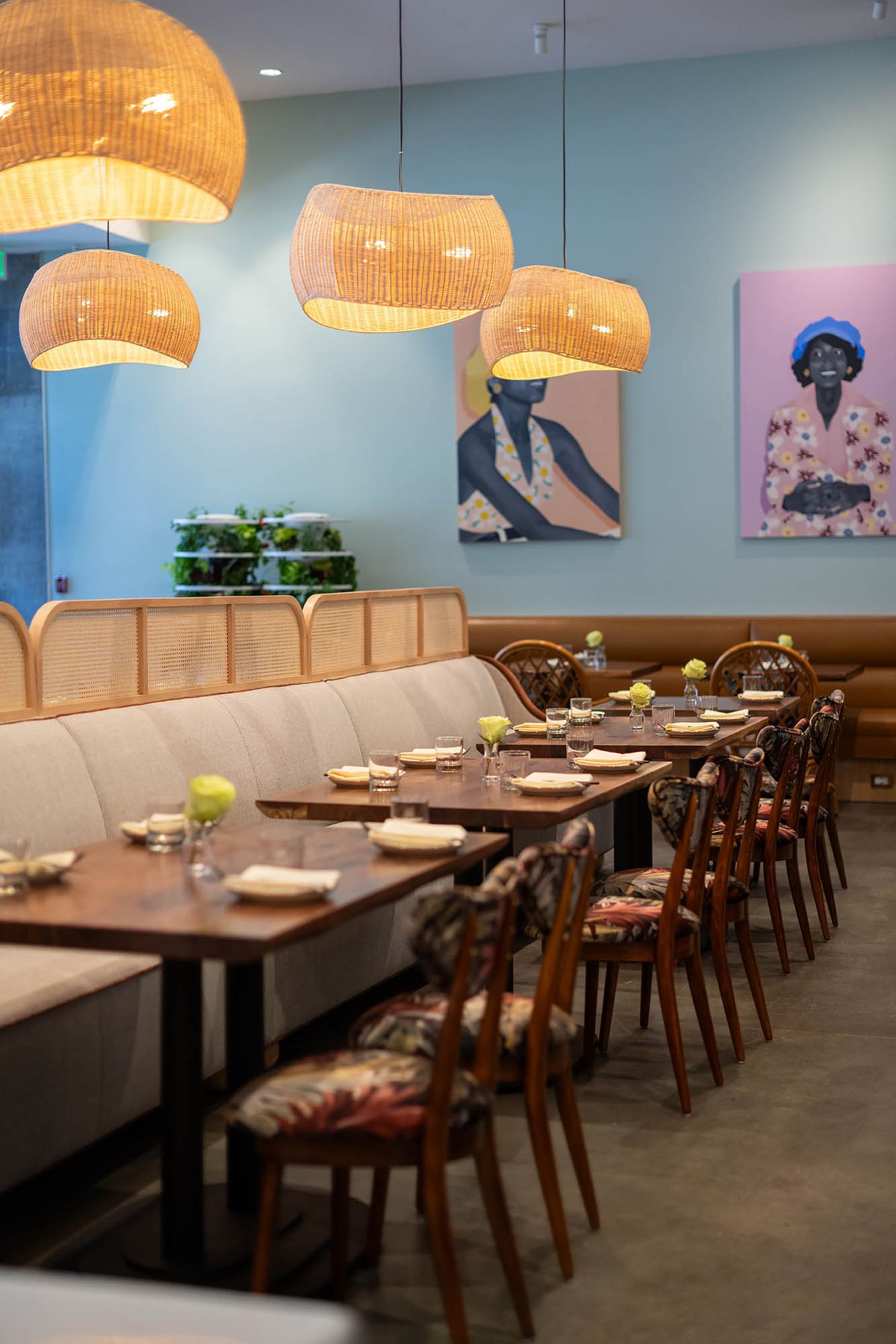 A light tan and grey run of tables and chairs at a new restaurant in Los Angeles named Joyce.