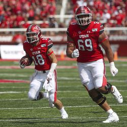 Utah Utes wide receiver Britain Covey (18) follows the lead of Utah Utes offensive lineman Simi Moala (69) during first half action in the University of Utah versus Northern Illinois football game at Rice-Eccles Stadium in Salt Lake City on Saturday, Sept. 7, 2019.