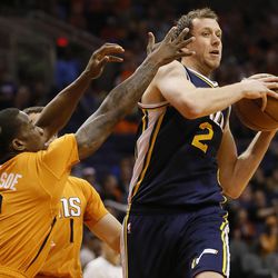Utah Jazz forward Joe Ingles, (2) of Australia, passes as Phoenix Suns guard Eric Bledsoe (2) defends during the first half of an NBA basketball game, Friday, Feb. 6, 2015, in Phoenix.