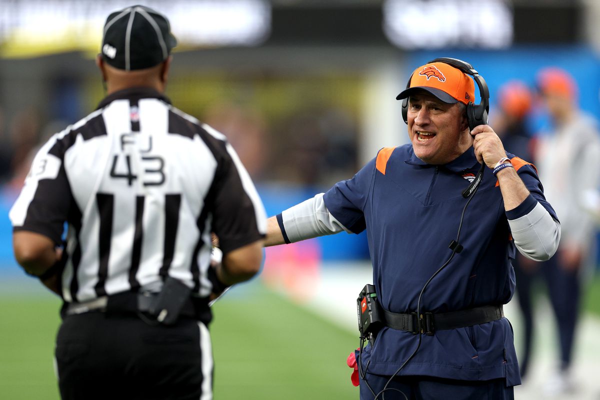 Head coach Vic Fangio of the Denver Broncos speaks with an official in the third quarter of the game the Los Angeles Chargers at SoFi Stadium on January 02, 2022 in Inglewood, California.