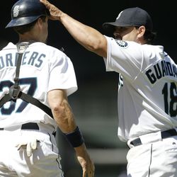 Catcher Pat Borders #37 and closing pitcher Eddie Guardado #18 of the Seattle Mariners celebrate after defeating the Texas Rangers 2-1 on July 3, 2005 at Safeco Field