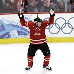 Canada's Sidney Crosby celebrates a goal by a teammate during a preliminary round men's ice hockey game against Norway at the Winter Olympics.     