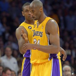 Los Angeles Lakers guard Kobe Bryant, right, is consoled by forward Metta World Peace after being injured during the second half of their NBA basketball game against the Golden State Warriors, Friday, April 12, 2013, in Los Angeles. The Lakers won 118-116. (AP Photo/Mark J. Terrill)