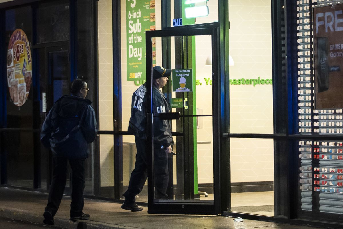 Chicago police investigate in a Subway at 6718 S. Stony Island Ave., where police said four teens were shot Sunday night as they stood in the parking lot of the Grand Crossing restaurant.
