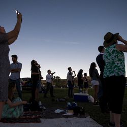 People gather to watch the total solar eclipse at Mann Creek Reservoir near Weiser, Idaho, on Monday, Aug. 21, 2017.