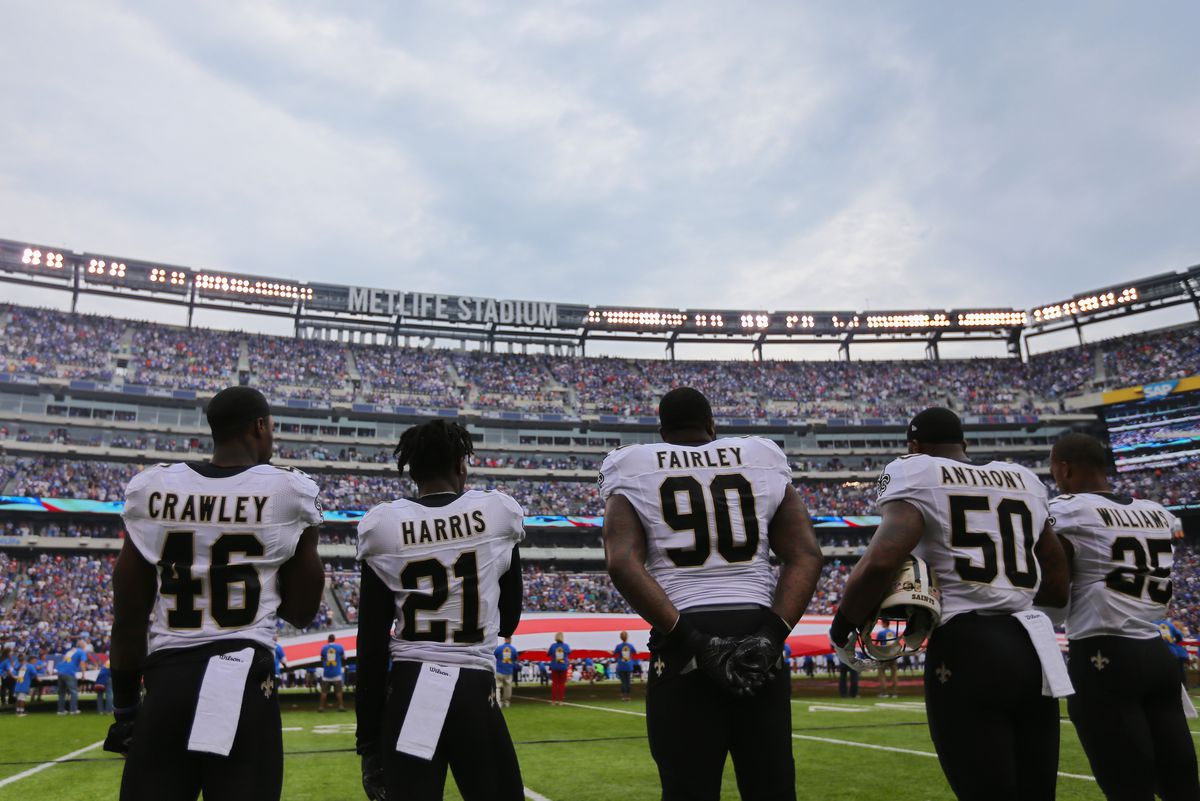 EAST RUTHERFORD, NJ - New Orleans Saints defensive tackle Nick Fairley (90) observes opening ceremonies with his teammates before a game against the New York Giants at MetLife Stadium.