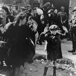 In this April 19, 1943 file photo, a group of Jews are escorted from the Warsaw Ghetto by German soldiers.