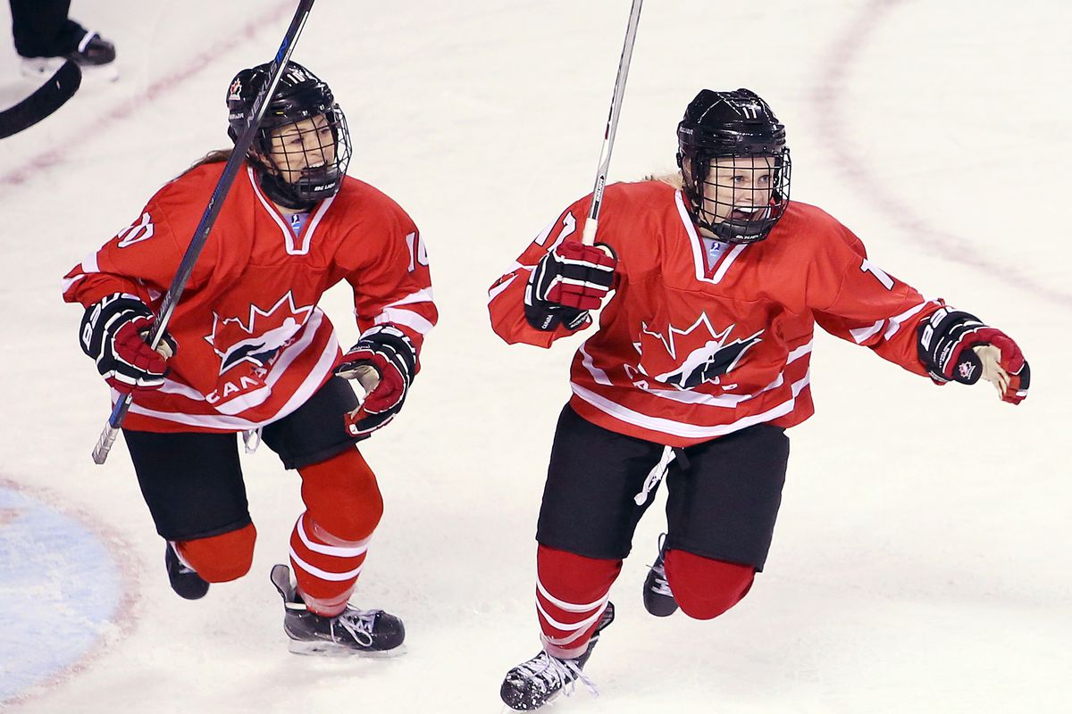 Kristin O’Neill #10 and Emma Maltais #17 of Team Canada celebrate a goal by teammate Ashton Bell #26 in a semifinal game against Team Russia during the 2016 IIHF U18 Women’s World Championships