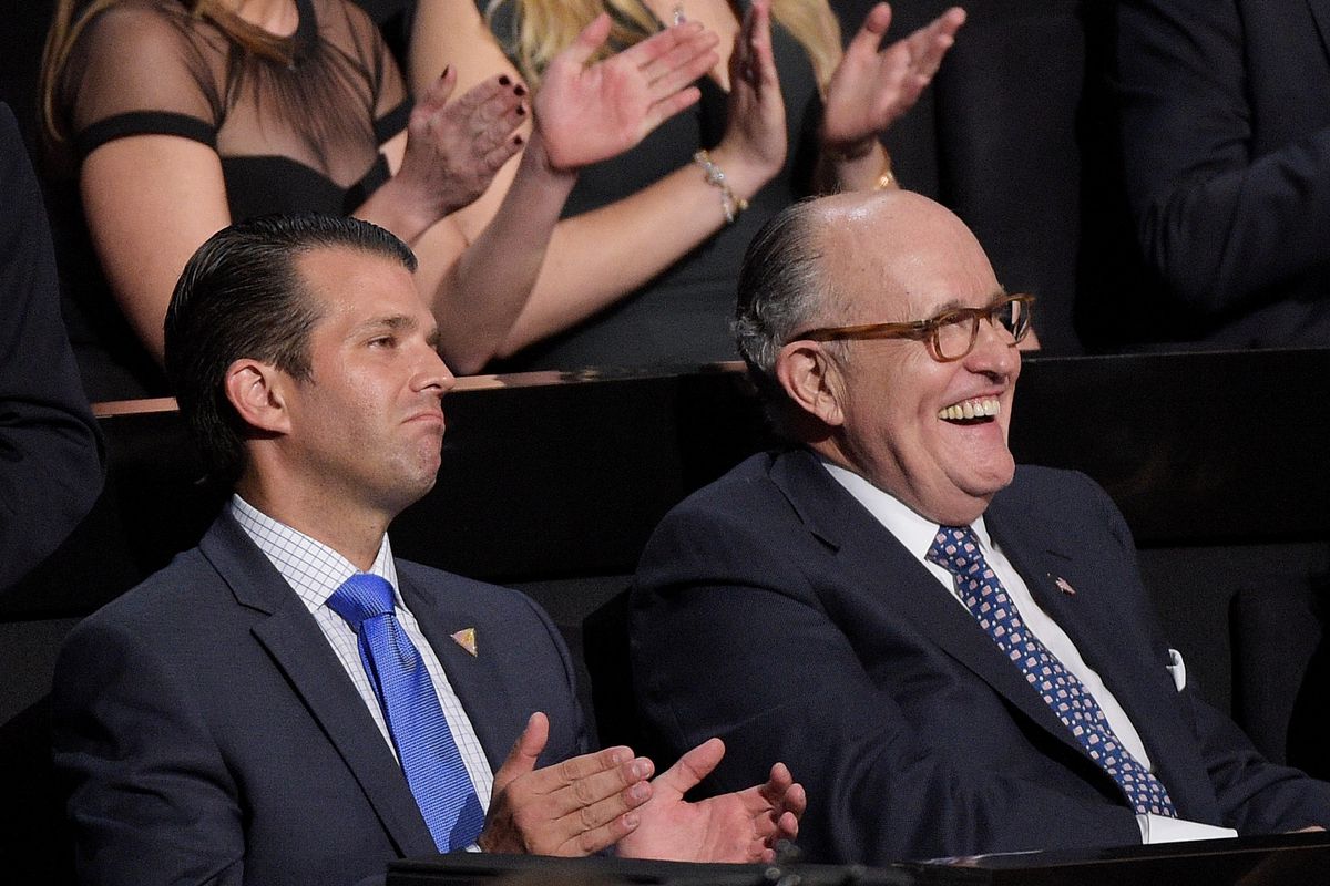 Donald Trump Jr. and former New York City Mayor Rudy Giuliani react during a speech on the first day of the Republican National Convention on July 18, 2016, at the Quicken Loans Arena in Cleveland, Ohio. 