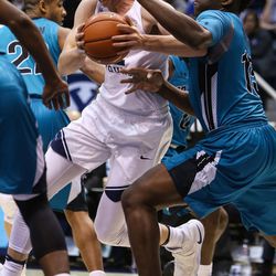 Brigham Young Cougars forward Eric Mika (12) drives against Coastal Carolina Chanticleers forward Amidou Bamba (15) during a game at the Marriott Center in Provo on Saturday, Nov. 19, 2016.