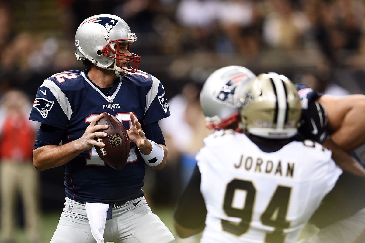 NEW ORLEANS, LA: New England Patriots quarterback Tom Brady (12) drops back to pass against the New Orleans Saints defense as defensive lineman Cameron Jordan (94) brings pressure at the Mercedes-Benz Superdome.