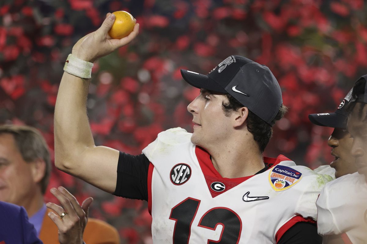 Georgia Bulldogs quarterback Stetson Bennett throws an orange after defeating the Michigan Wolverines during the Orange Bowl college football CFP national semifinal game at Hard Rock Stadium.&nbsp;