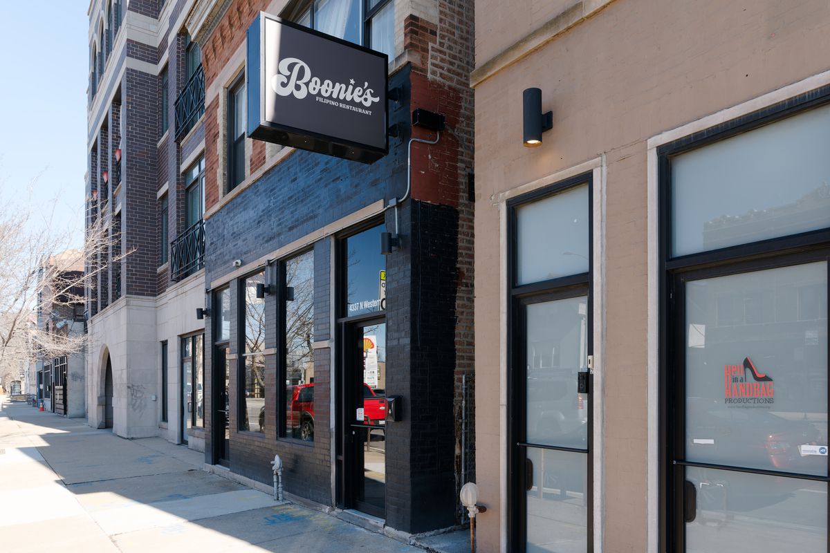 A brick building painted black with a sign that reads “Boonie’s Filipino Restaurant.”