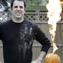 "Extreme" pumpkin carver Tom Nardone of Birmingham, Mich., shows off this year's jack-o'-lantern, a flame-throwing cannon that shoots 15 feet into the air. 