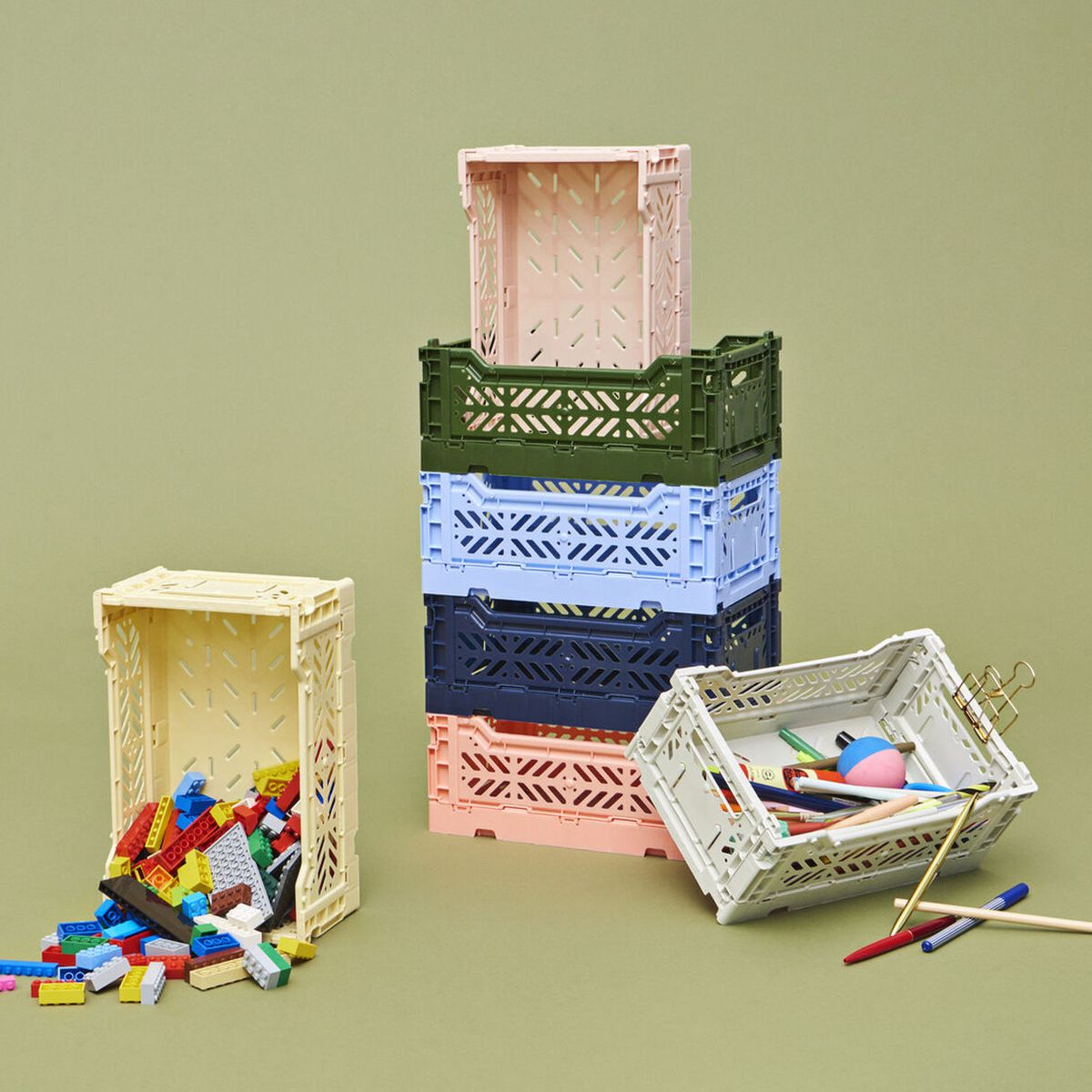 Stacks of colorful plastic crates with toy bricks inside.