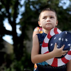 Tayson Dale, 6, of Orem, stands as the Mormon Battalion color guard passes by during the Days of ‘’47 Parade in Salt Lake City on Wednesday, July 24, 2019.