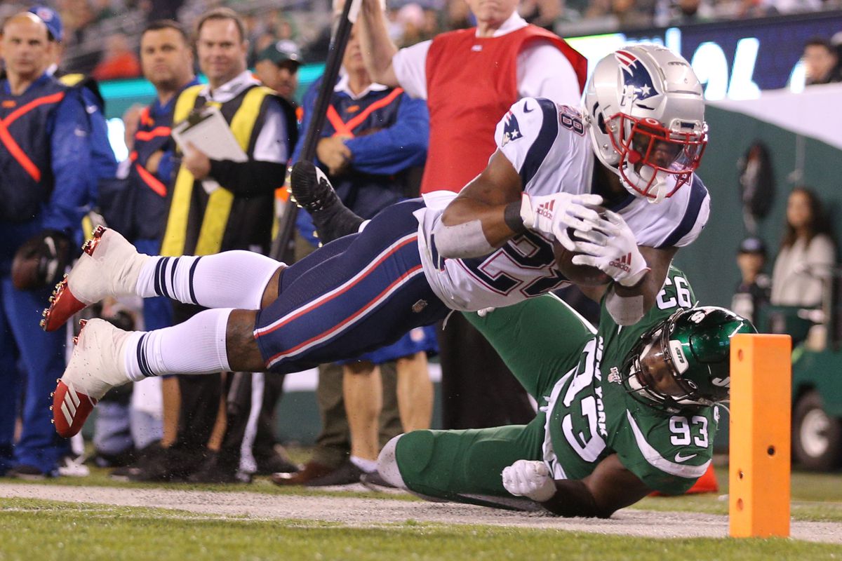 New England Patriots running back James White dives for the end zone and is forced out of bounds at the one yard line by New York Jets linebacker Tarell Basham during the fourth quarter at MetLife Stadium.