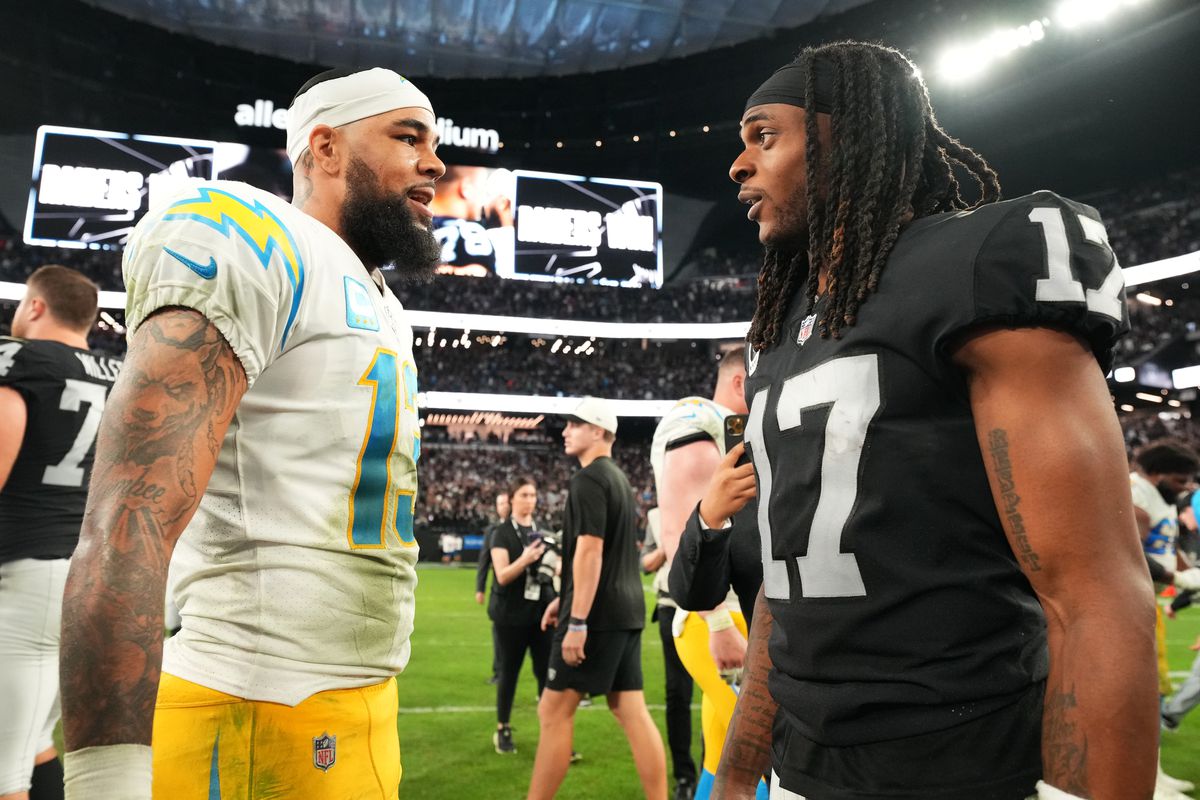 Keenan Allen #13 of the Los Angeles Chargers and Davante Adams #17 of the Las Vegas Raiders interact after the game at Allegiant Stadium on December 04, 2022 in Las Vegas, Nevada.