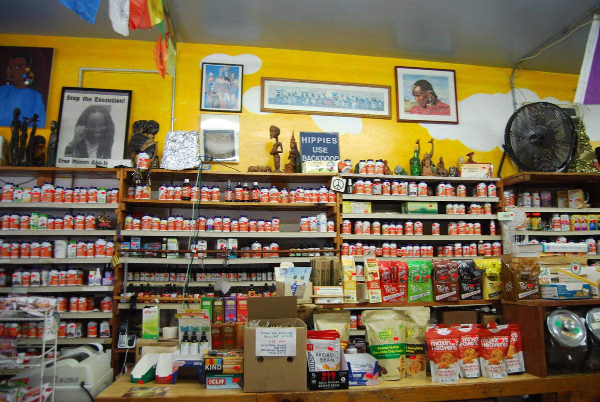 The store's many shelves are lined with vitamins, tinctures, teas, toothpaste, chips, and seed packets.