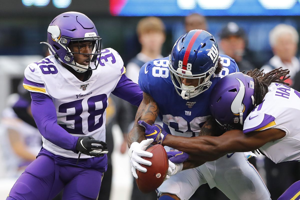 Minnesota Vikings defensive back Kris Boyd and defensive back Anthony Harris knock the ball out of the hands of New York Giants tight end Evan Engram during the second half at MetLife Stadium.
