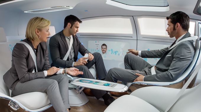 Passengers in Mercedes Benz's concept F 015 play with their gadgets.