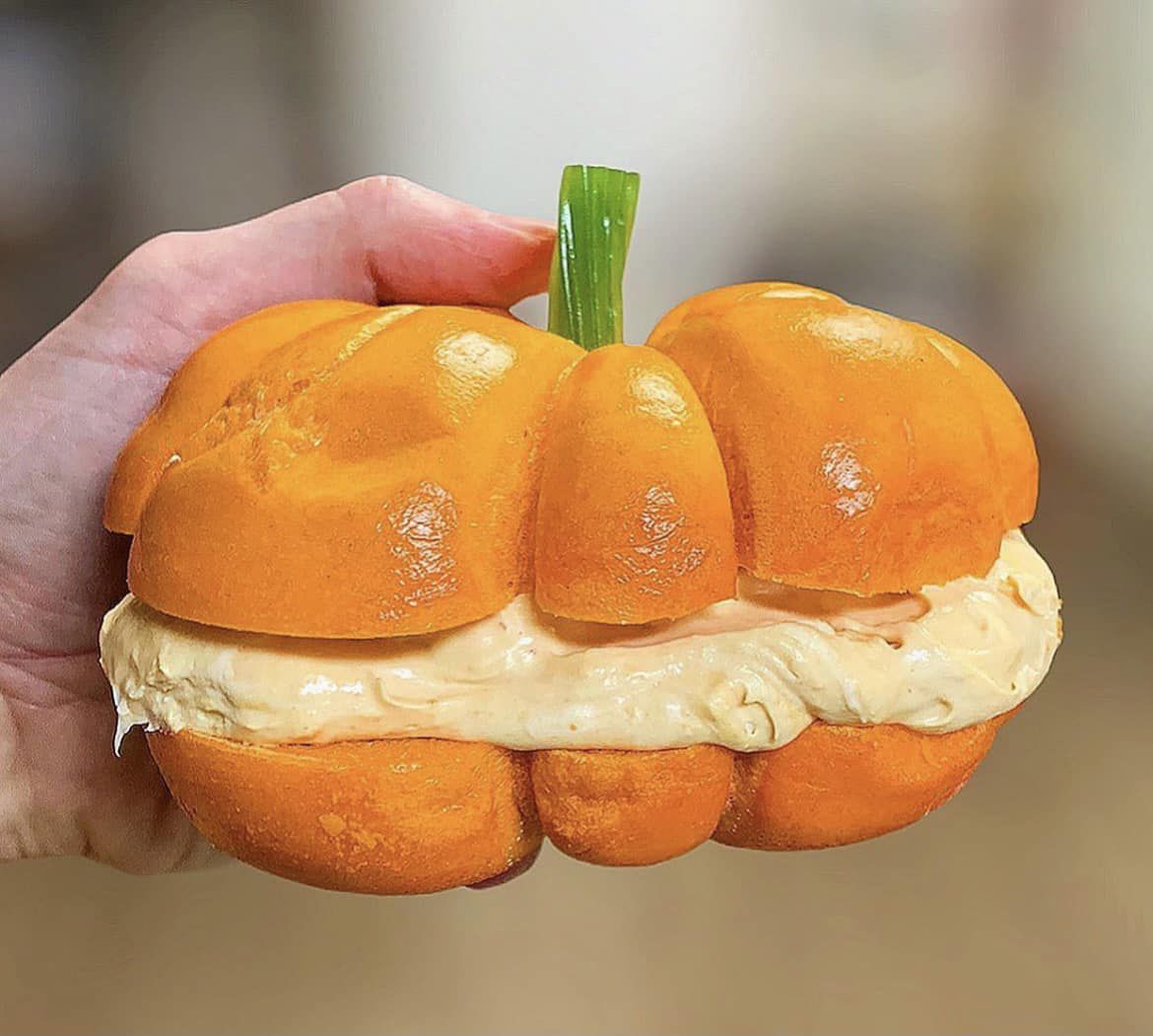 An orange bagel shaped like a pumpkin