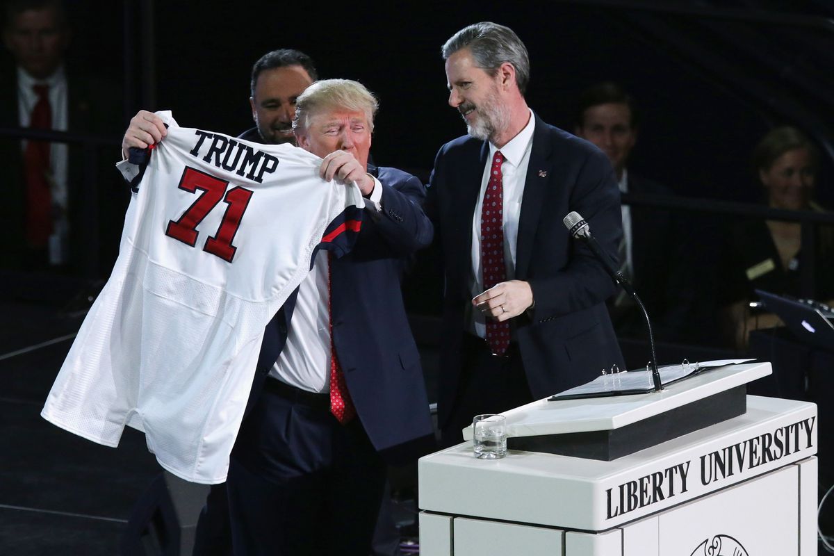 At the Liberty University convocation, Liberty president Jerry Falwell Jr. presents Donald Trump with a sports jersey.