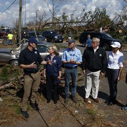 FEMA director Brock Long, left, talks with from left, Homeland Security Secretary Kirstjen Nielsen, Florida Gov. Rick Scott, President Donald Trump, first lady Melania Trump and Margo Anderson, Mayor of Lynn Haven, right, as they tour a neighborhood affected by Hurricane Michael, Monday, Oct. 15, 2018, in Lynn Haven, Fla. (AP Photo/Evan Vucci)