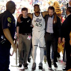 Utah Jazz guard Donovan Mitchell (45) is helped off the court after injuring his ankle in the fourth quarter of Game 5 of the NBA playoffs against the Houston Rockets at the Toyota Center in Houston on Tuesday, May 8, 2018. The Jazz lost 102-112.