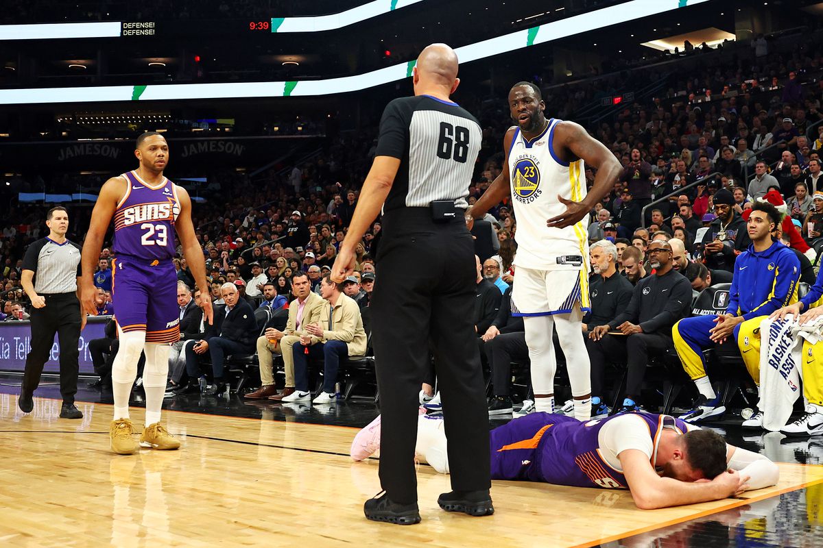 Draymond Green arguing with a ref while Jusuf Nurkić is on the ground. 