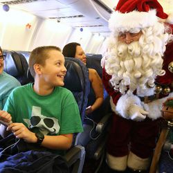 Brandy Jackson and her son, Michael Strom, talk with Santa on a plane as they join American Airline's 11th annual Snowball Express at the Salt Lake City International Airport on Sunday, Dec. 11, 2016, an event for children of fallen military heroes. Ten chartered American aircraft departed numerous cities — including Salt Lake City — to pick up nearly 1,800 children and spouses for an all-expense-paid journey to Dallas-Fort Worth area. While there, the families will participate in a series of activities starting with a Texas-sized welcome, a tour of the Fort Worth Museum of Science and History, a night of jousting fun at Medieval Times and a private concert by Academy Award-nominated actor Gary Sinise and the Lt. Dan Band.