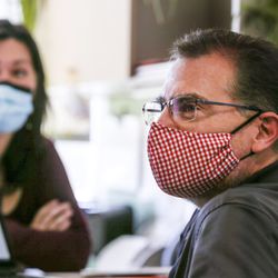 Chantel Ikeda, a nurse with the Salt Lake County Health Department, left, trains Shawn Gonzales, an environmental health scientist with the county, how to trace the contacts of people infected with COVID-19 in Salt Lake City on Friday, April 10, 2020.