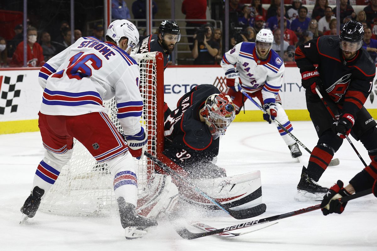 Antti Raanta #32 of the Carolina Hurricanes makes a first period save against Ryan Strome #16 of the New York Rangers in Game Seven of the Second Round of the 2022 Stanley Cup Playoffs at PNC Arena on May 30, 2022 in Raleigh, North Carolina.