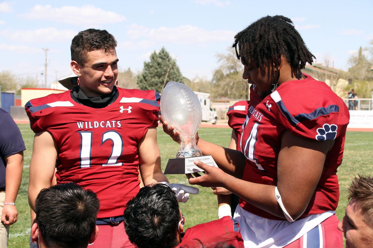 Senior Wildcats Rudy Alarcon, left, and Tyrell Rickman admire the Borderland Bowl Trophy following a 40-0 victory over the Santa Teresa High Desert Warriors.