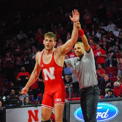 Nebraska’s Eric Schultz gets his hand raised after winning his 197-pound match against Michigan’s Jackson Striggow Friday night at the Devaney Sports Center.