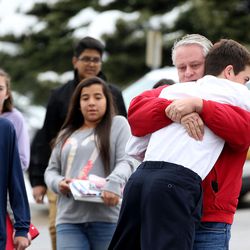 Dan Fowers, a ningth-grader, is lifted off the ground during a hug from his father, David, after a lockdown was lifted at Mueller Park Junior High School in Bountiful on Thursday, Dec. 1, 2016. Fowers was in the room when his classmate fired a gun.
