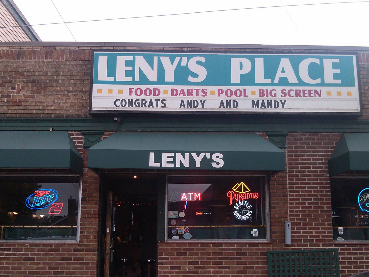 The outside of Leny’s Place, with the bar’s name out front and a brick exterior.