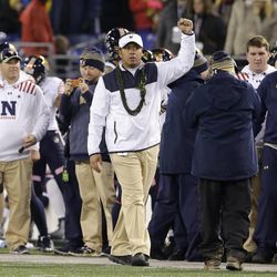 Navy head coach Ken Niumatalolo, center, celebrates in the final moments of the Army-Navy NCAA college football game last December in Baltimore. 