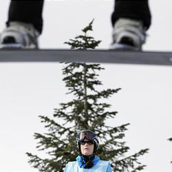 A judge inspects a jump during the first snowboard cross qualifications run at the Vancouver 2010 Olympics on Monday.