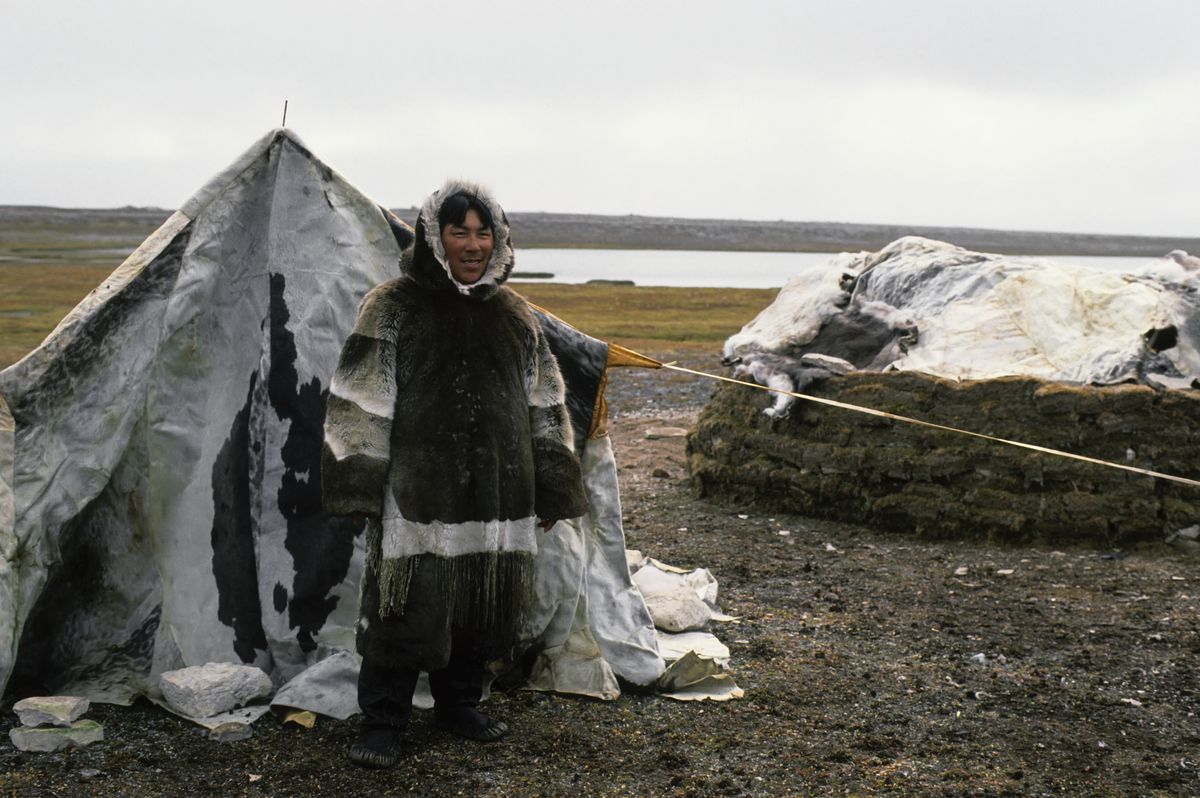 An Inuit man wearing sealskin.