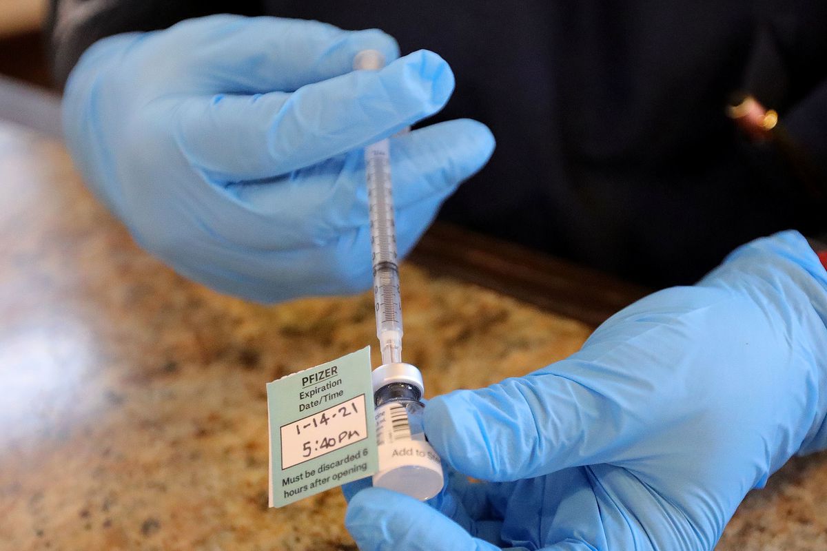 A pharmacist prepares a Pfizer-BioNTech COVID-19 vaccine at Summit Senior Living in Kearns on Thursday, Jan. 14, 2021. 