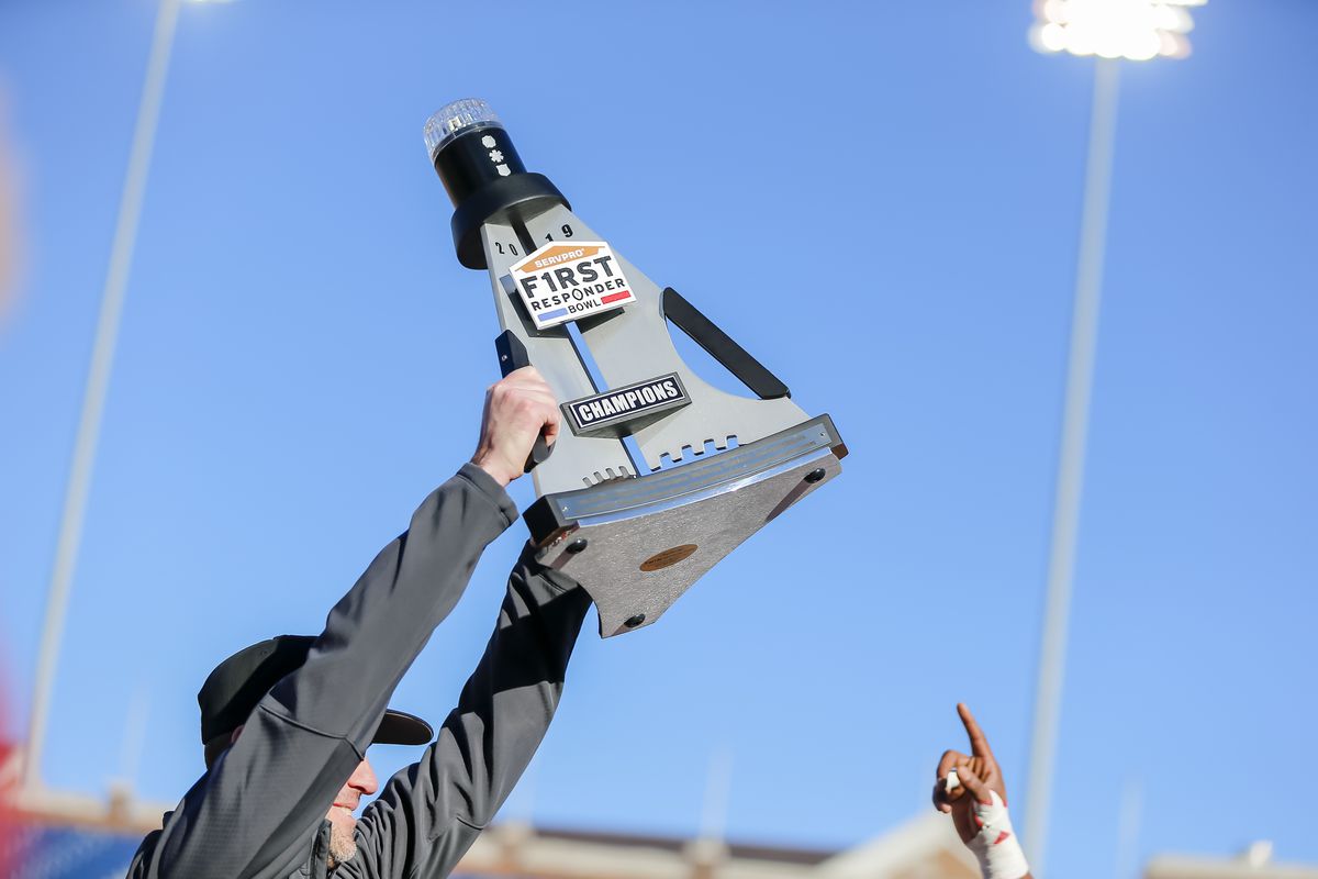 Western Kentucky Hilltoppers head coach Tyson Helton holds up the First Responders Bowl trophy after the game between the Western Kentucky Hilltoppers and the Western Michigan Broncos on December 30, 2019 at Gerald Ford Stadium in Dallas, Texas.